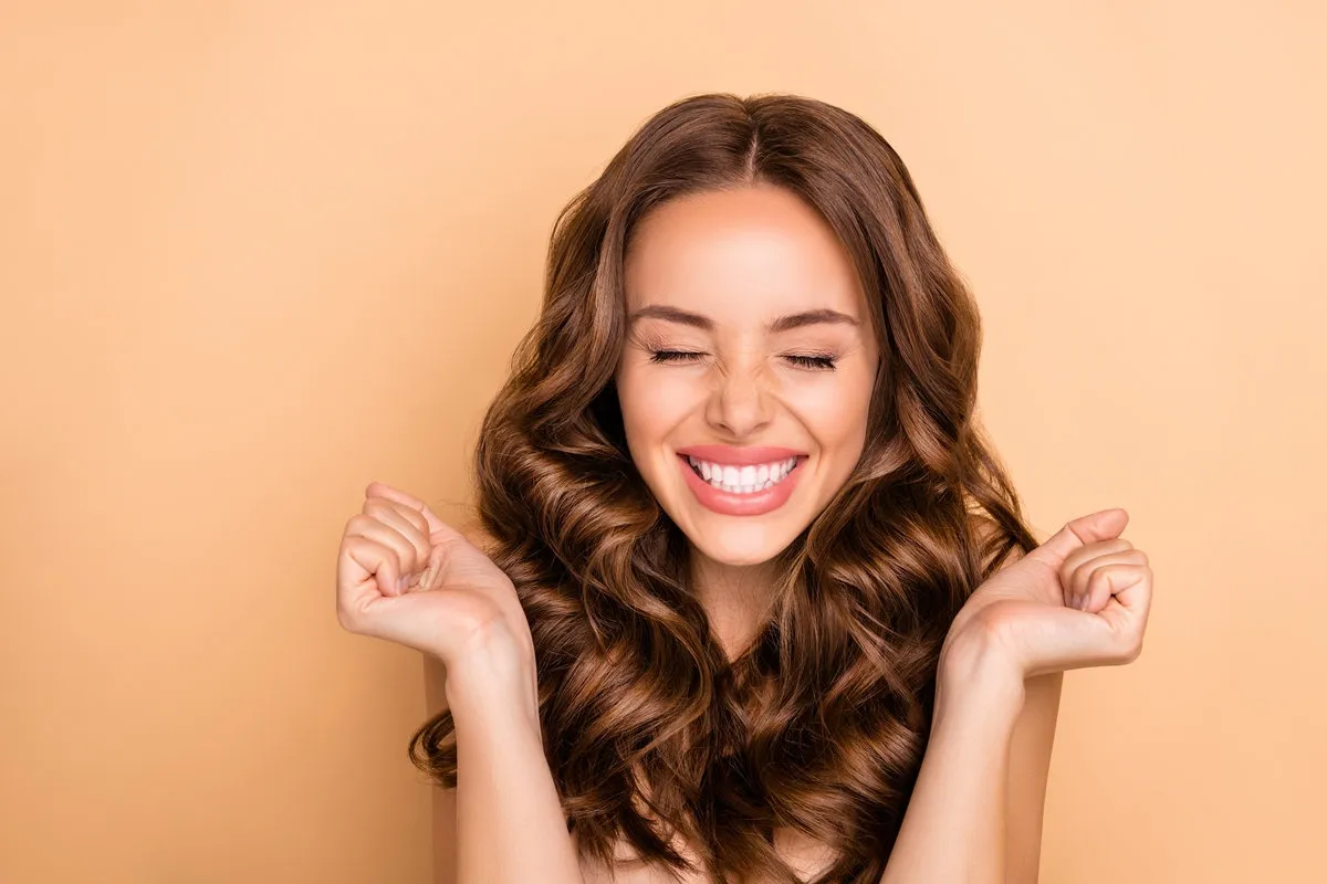 Close-up portrait of nice attractive lovely gorgeous girlish excited cheerful cheery, dreamy lucky wavy-haired girl enjoying expecting pleasure isolated on beige pastel color background