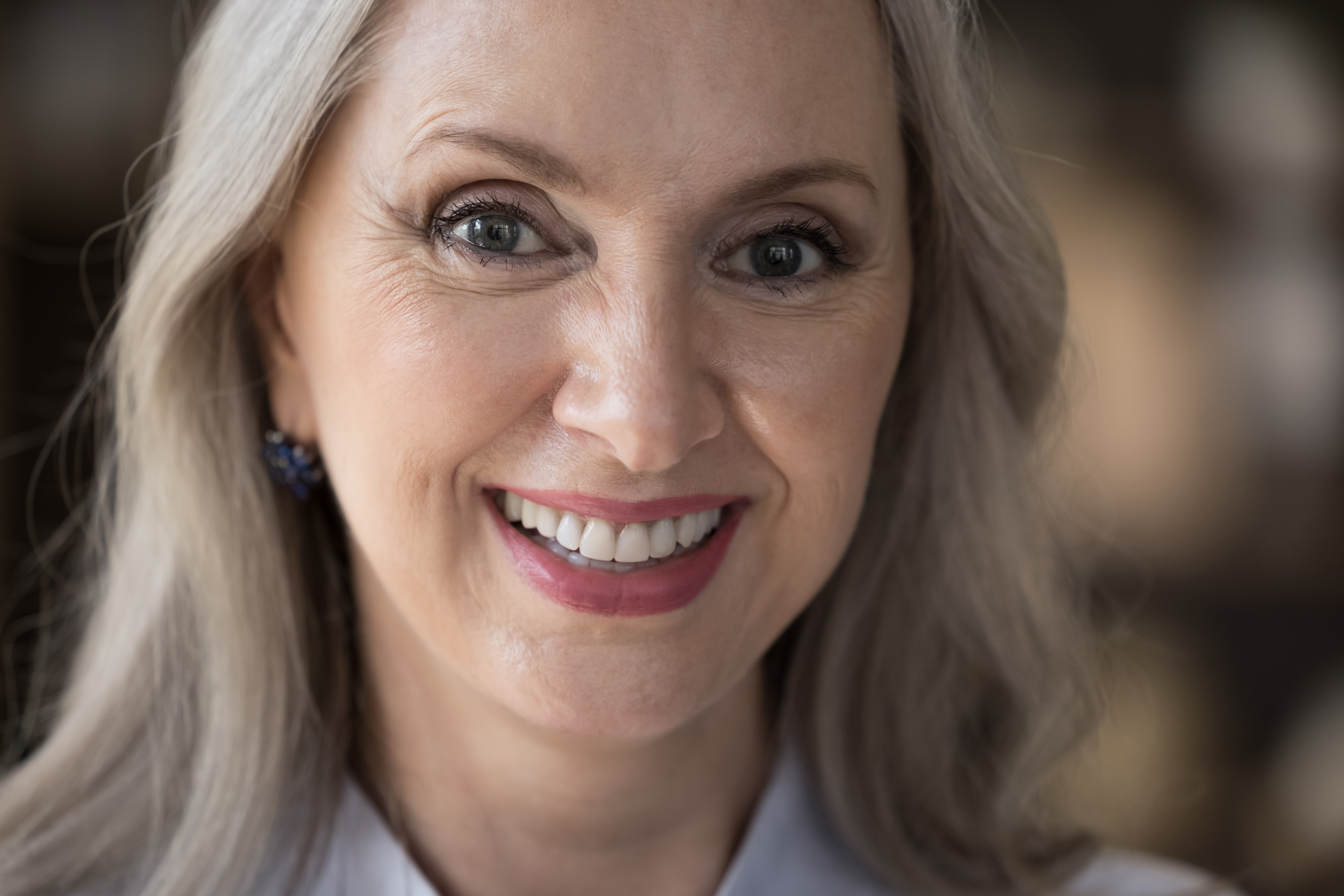 Close up optimistic beautiful middle-aged woman looking at camera, having wide charming smile advertise dental check up, clinic services for older citizen. Successful businesswoman portrait concept
